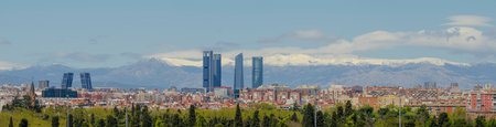 Panoramic view of Madrid, the capital of Spain, with the partially snow-covered mountains in the background.の写真素材