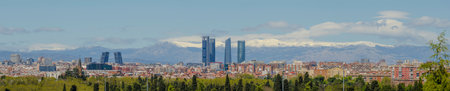 Panoramic view of Madrid, the capital of Spain, with the partially snow-covered mountains in the background.の写真素材