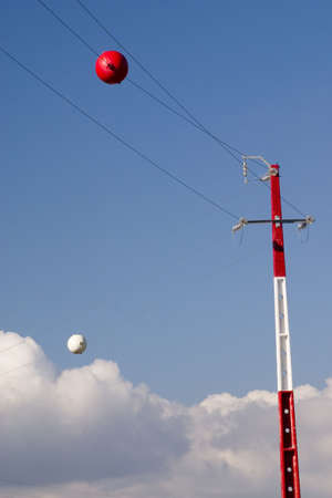 Red and white electricity towerの写真素材