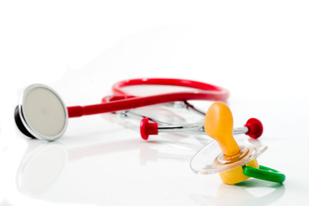 red stethoscope with green pacifier isolated