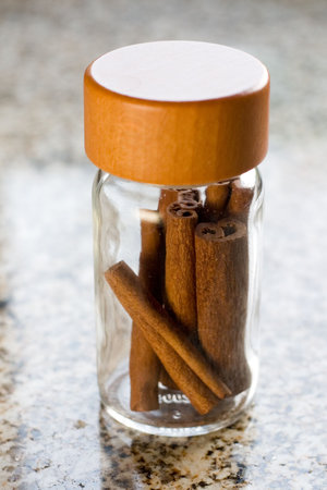 cinnamon on jar shot in a stone backgroundの写真素材