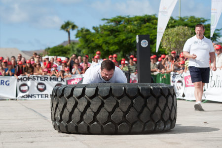 CANARY ISLANDS - SEPTEMBER 03: Jimmy Laureys (l) from Beligium lifting and rolling a wheel (weights 400kg) 8 times during Strongman Champions League in Las Palmas September 03, 2011 in Canary Islands, Spain のeditorial素材