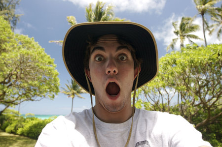 A shocked young man in a tropical locationの写真素材