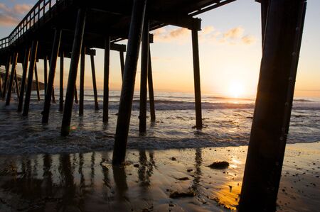 A Pier silhouetted at sunsetの写真素材