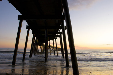 A Pier silhouetted at sunsetの写真素材