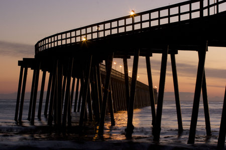 A Pier silhouetted at sunsetの写真素材