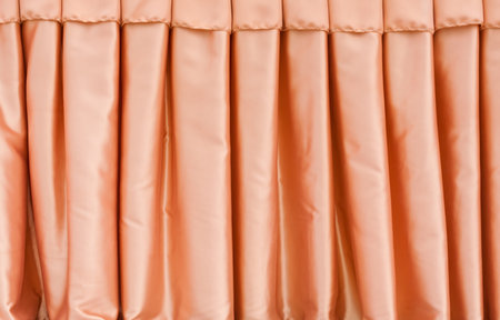 Folded orange fabric curtain full of frame