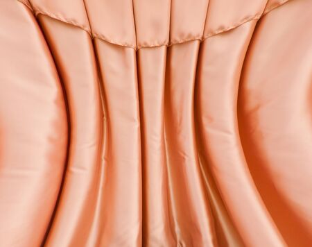 curve folded orange fabric curtain full of frameの写真素材