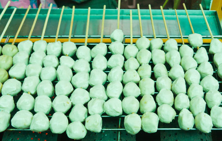 Group of meatballs stack with sticks  grilling on metal stoveの写真素材