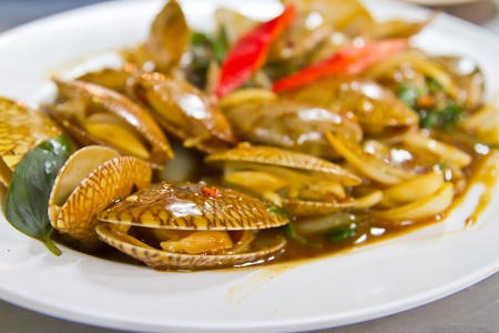 Spicy fried clams on plastic dish ready to eatの写真素材