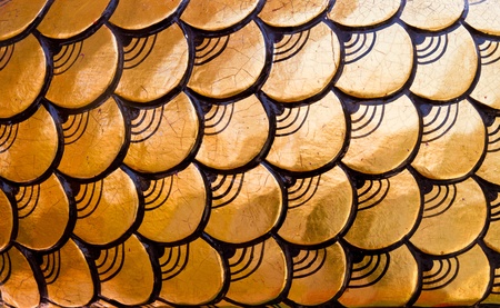 Craved golden dragon scales pattern texture backgroundの写真素材