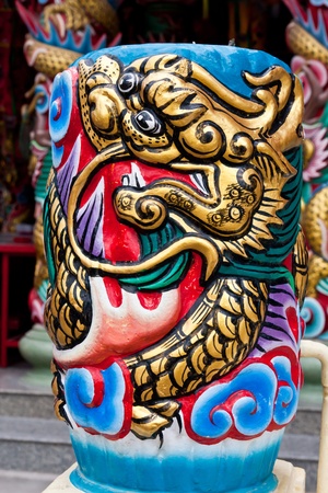 Golden dragon pattern wrapped on blue pillarの写真素材