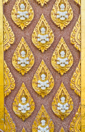 Angel decoration on wall in temple in Thailandの写真素材