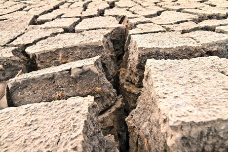 arid ground land cracked by drought from global warmingの写真素材