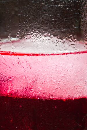 Red cream soda syrup in frozen glass with droplets  close upの写真素材