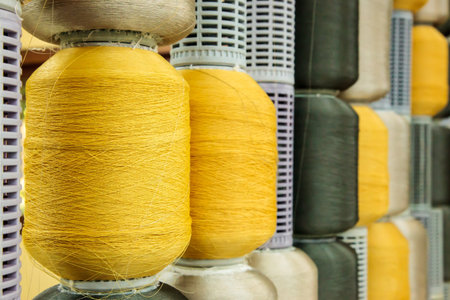 Yellow and gray silk thread roll in silk spool