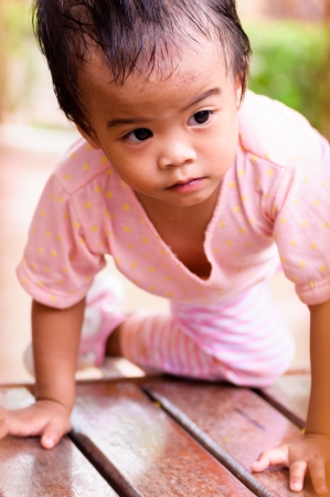 Asian baby girl playing in playground aloneの写真素材
