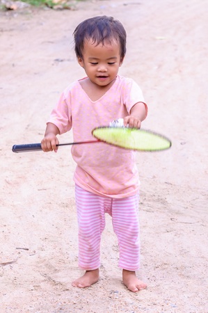 Asian baby girl playing with badminton racketの写真素材