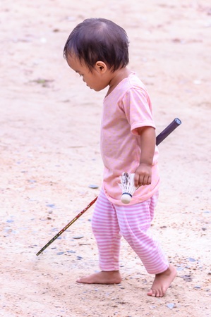 Asian baby girl playing with badminton racketの写真素材