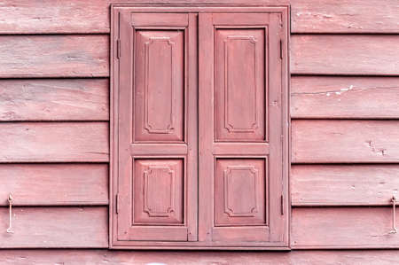 Closed wooden windows on plank striped wooden wallの写真素材