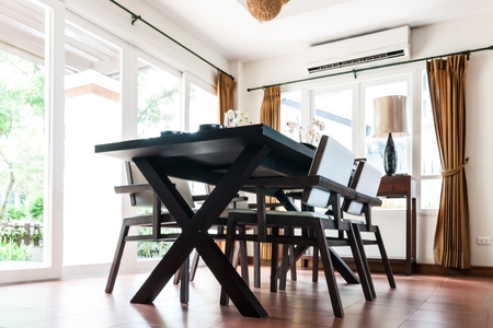 Black table and chairs in white living room with doors and windowsのeditorial素材