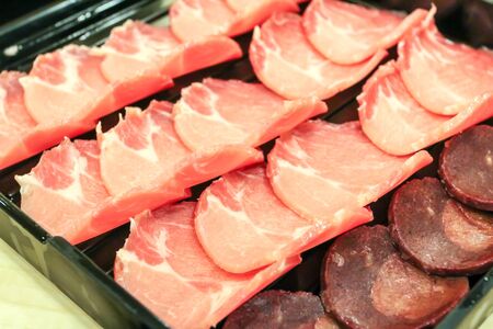 raw sliced pork in black containerの写真素材