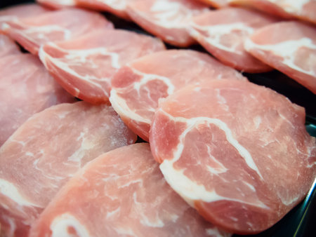 Raw sliced pork in container ready for cookingの写真素材