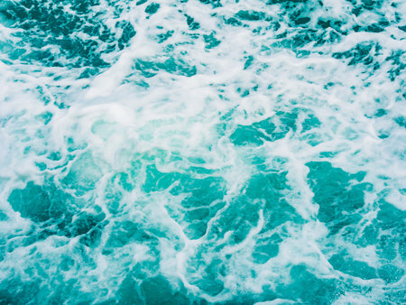 Splashing water in blue turquoise sea background