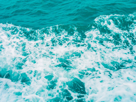 Splashing water in blue turquoise sea background