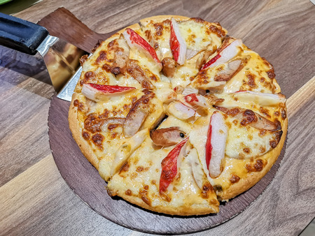 Italian traditional fast food pizza on wooden tableの写真素材