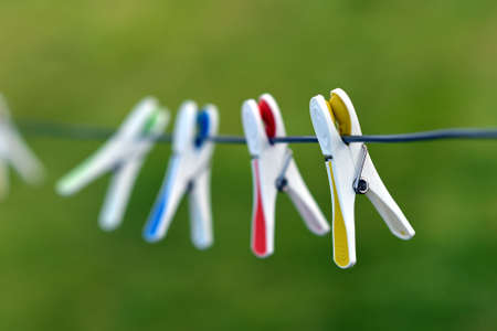 Plastic clothes pegs on a washing lineの写真素材