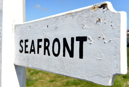 Seafront sign black on white traditional finger postの写真素材
