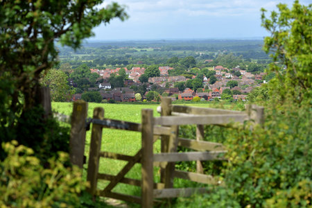 Gate or style overlooking typical English country village, Sussexの写真素材