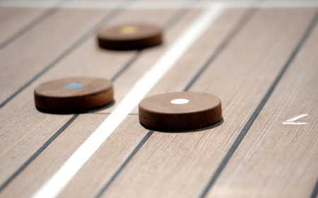 Shuffleboard game on the wooden deck of a cruise ship
