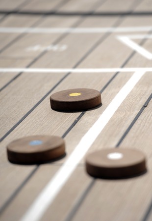 Shuffleboard game on the wooden deck of a cruise shipの写真素材