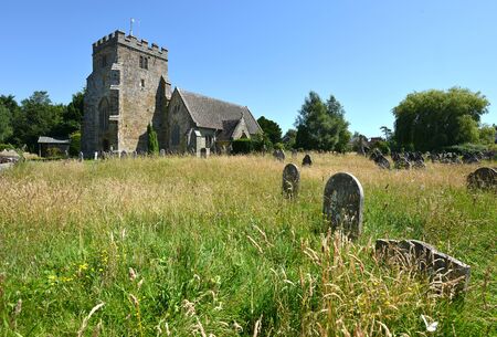 Typical country village church with overgrown gravesの写真素材