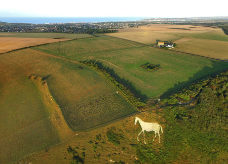 Aerial shot of white horse carved into the chalk at High and Over, South Downs National Parkの写真素材