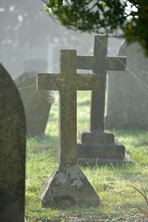 Misty graveyard,crosses and graves backlitの写真素材