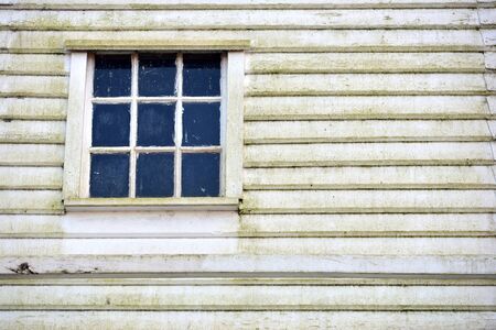 Old wooden sash window and weather boardingの写真素材