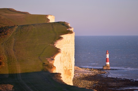 Lighthouse at Beachy Head with sheer chalk cliffsの写真素材
