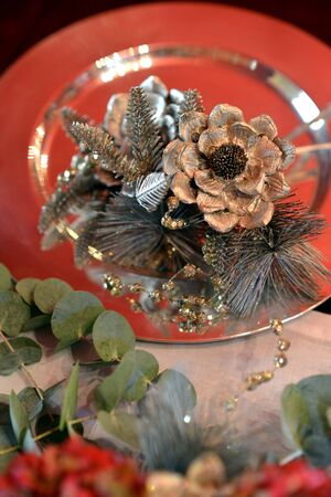 Christmas dining table fully dressed with decorations and foliage.の写真素材