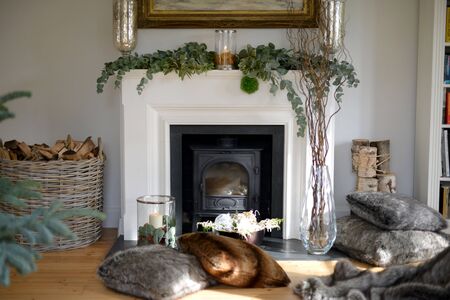 Traditional festive christmas decorated fireplace with candlesの写真素材