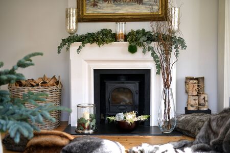 Traditional festive christmas decorated fireplace with candlesの写真素材