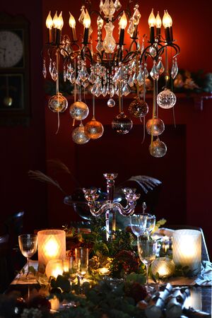 Christmas dining table fully dressed with decorations and foliage.の写真素材