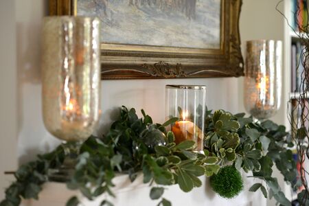 Traditional festive christmas decorated fireplace with candlesの写真素材
