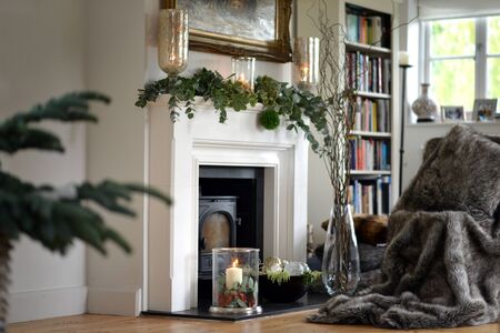 Traditional festive christmas decorated fireplace with candlesの写真素材