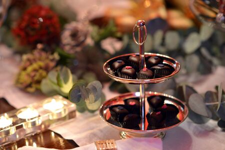 Christmas dining table fully dressed with decorations and foliage.の写真素材