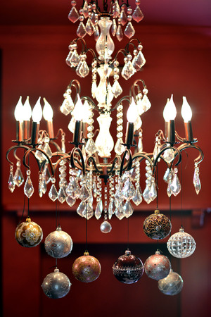 Traditional Christmas glass baubles hanging from a chandelierの写真素材