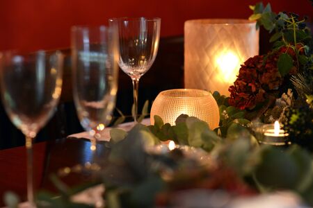 Christmas dining table fully dressed with decorations and foliage.の写真素材