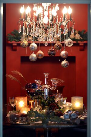 Christmas dining table fully dressed with decorations and foliage.の写真素材